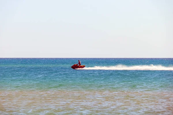 A man rides a jet ski in the open sea — Stock Photo, Image