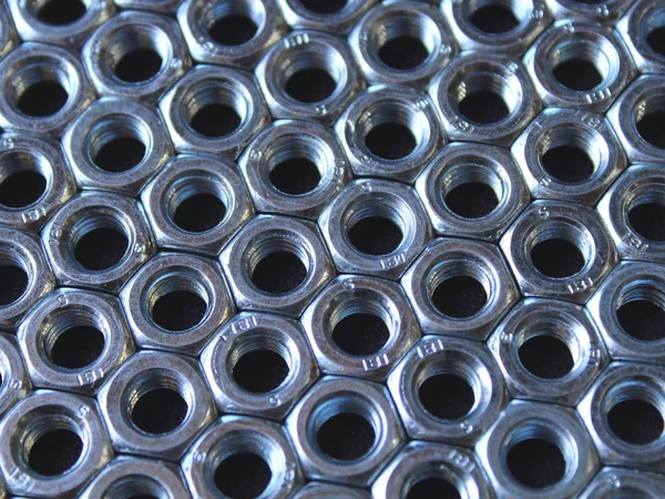 texture of industrial nuts on a black backing