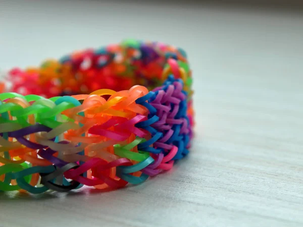 multi-colored rubber bracelet weaving on a table close-up