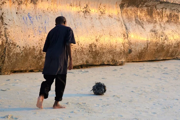 Boy plays football with a homemade ball of cellophane bags. Zanzibar