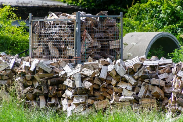 Firewood is packed in containers to be prepared for a cold winter