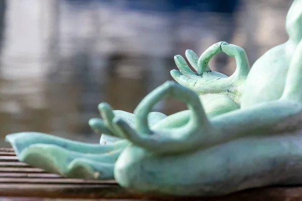 Close up hand. Stone frog doing yoga outdoor. Zen relax and relaxation yoga at the nature background. Healthy and Lifestyle Concept