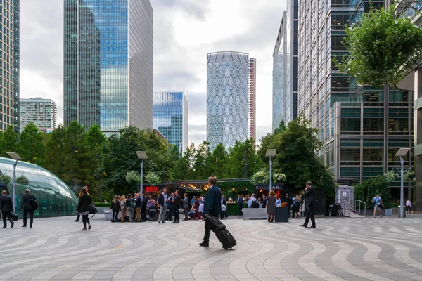 Personas descansando al aire libre y entrando en la estación de metro después de un día de trabajo en Canary Wharf - el sitio de los edificios más altos y un importante centro financiero en Londres. Reino Unido septiembre 2019, Inglaterra . — Foto de Stock
