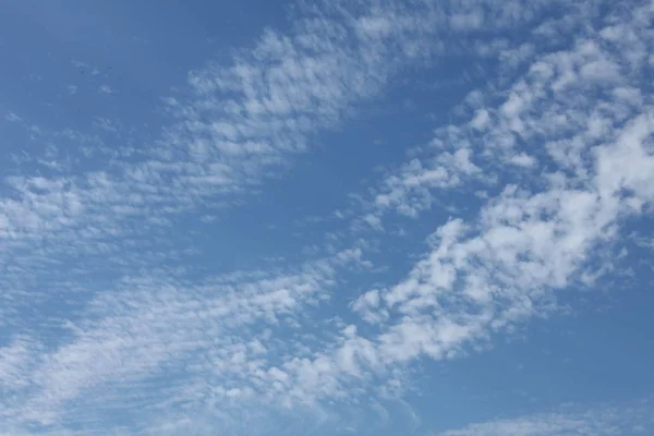 Grey big clouds in the blue sky