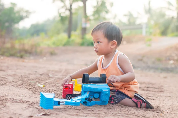 Bambino giocare giocattolo su terreno all'aperto — Foto Stock