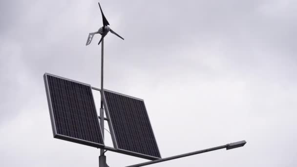 Solar panels and a small wind turbine for the production of environmentally friendly energy — Stock Video