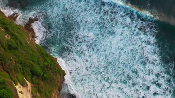 Abstraktní letecký pohled na mořské vlny, které se hroutí na skalnaté pobřeží — Stock video
