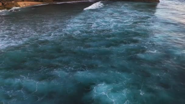 Abstract aerial view of ocean waves crashing on rocky shoreline — Stock Video