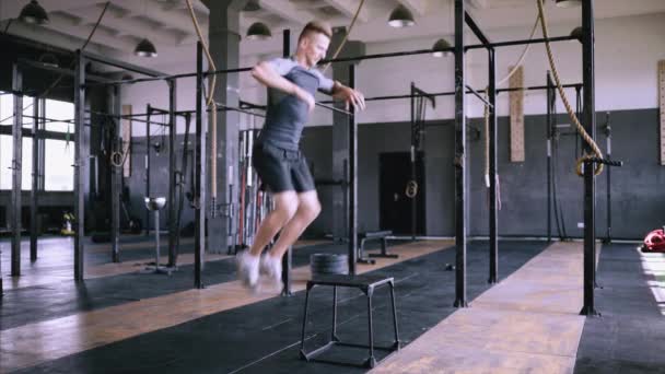 Atletische man doet Box springt in de fabriek Gym — Stockvideo