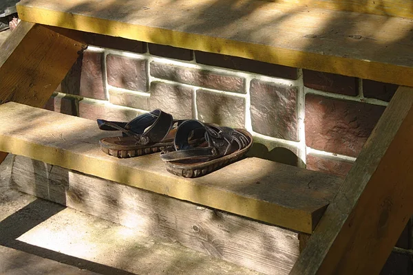 木制门廊上的旧凉鞋 — 图库照片