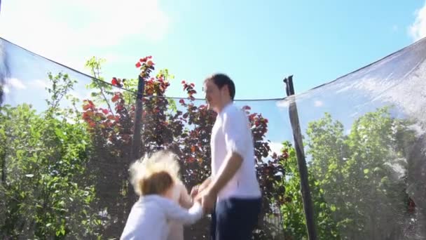 Father with son have fun on trampoline. Slow motion shot. — Stock Video