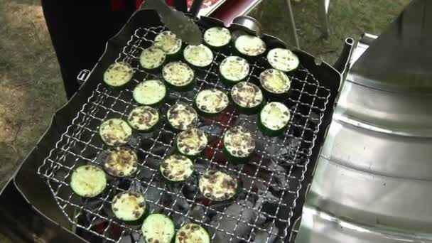 Cooking zucchini vegetables in grill grate. Vegan food preparation. Handheld — Stock Video