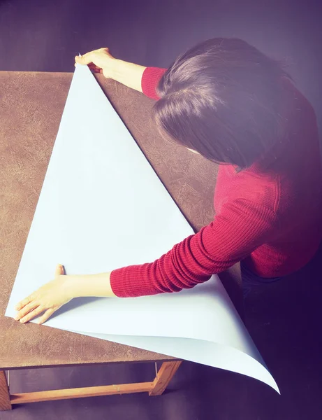 Real Woman Folding Light Blue Sheet Paper — Stock Photo, Image