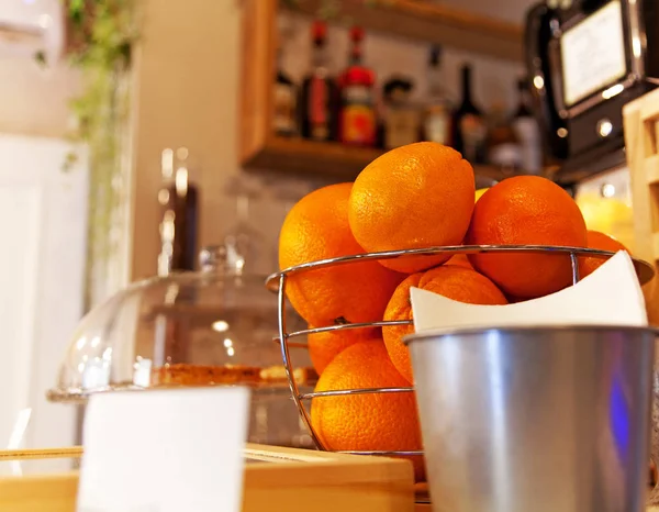 Apelsiner i en korg på en bänk bar — Stockfoto