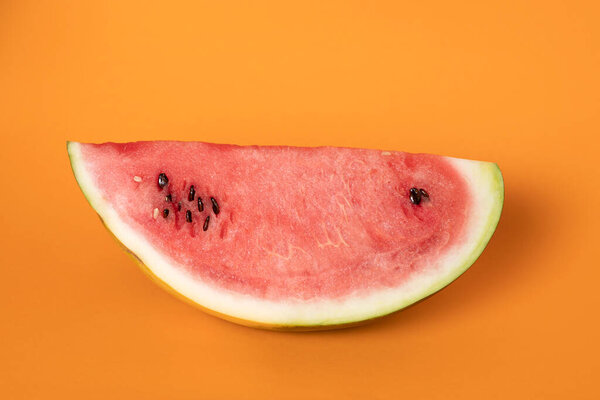 closeup part of refreshing watermelon on orange background