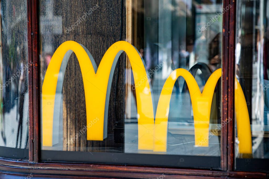 Closeup of a golden McDonalds sign. fast food in madrid spain 08.06.2025