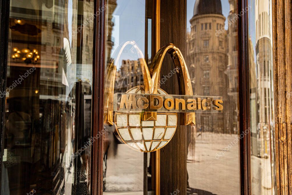 Fast food company logo in a city street.  McDonalds in Madrid, spain  08.06.2025