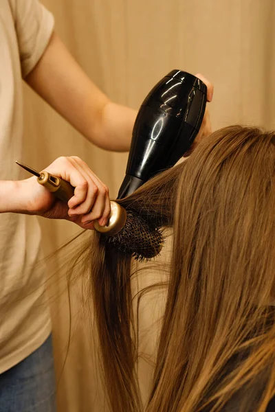 Hairdresser styling little girl client