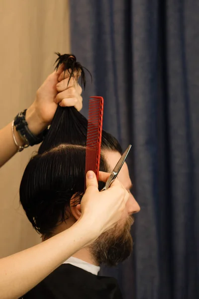 Male haircut. Scissors cut hair