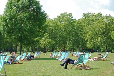 Green Park, Londra, İngiltere'de şezlonglarda dinlenmek