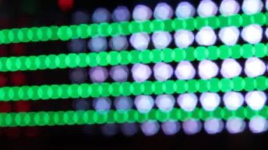 Bokeh neon disko ışıkları lunapark gezisi sentetik dalga arka plan gökkuşağı ışıkları gece yanıp sönen insanları hareket ettiriyor.