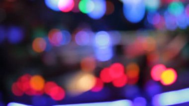 Disko ışıkları lunapark gezisi sentetik dalga gökkuşağı bokeh ışıkları gece stoklarında, görüntülerde, videolarda yanıp sönen insanları hareket ettiriyor.
