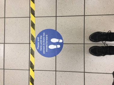 Coronavirus covid-19 için Londra süpermarketinde sosyal mesafeler. Virüsün yayılmasını önlemek için hükümet yönergeleri takip ediliyor.