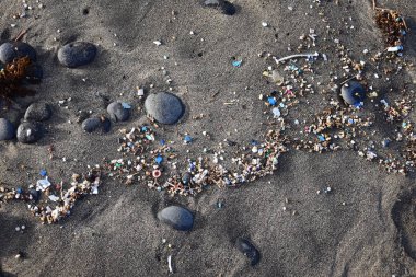 Microplastics on a beach. Famara Beach, Lanzarote. clipart