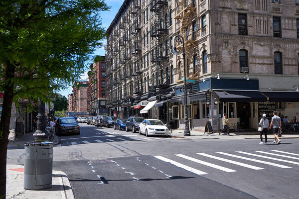 Old apartment buildings with fire escapes located on the Lower east Side at Broome Street near Ludlow Street.