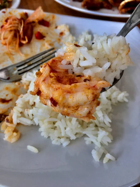 Shrimp and rice are in a spoon.Thai food