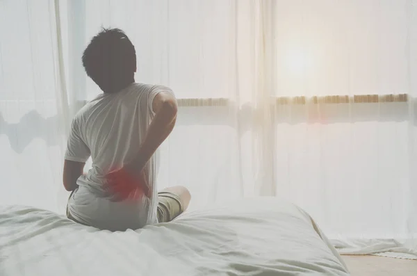 Asian women Have back pain In the morning.Back pain is caused by a mattress.Do not focus on objects.
