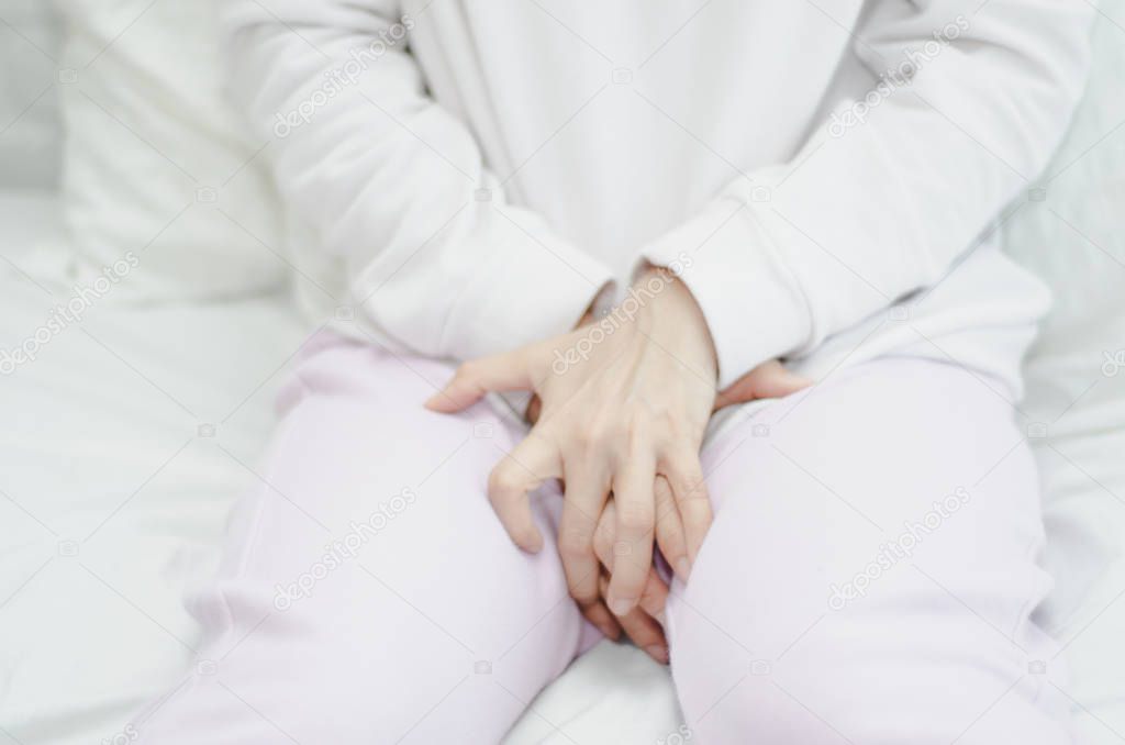 Woman wearing pink pants the itching on vaginal. Genital itching caused by fungus in underwear.
