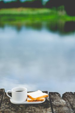 Sabahları ahşap katta kahvaltı servis edilmektedir. Kahve ve ekmek içeren kahvaltı. Nesnelere odaklanmayın.