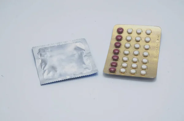 避孕药和避孕套在地板上 — 图库照片