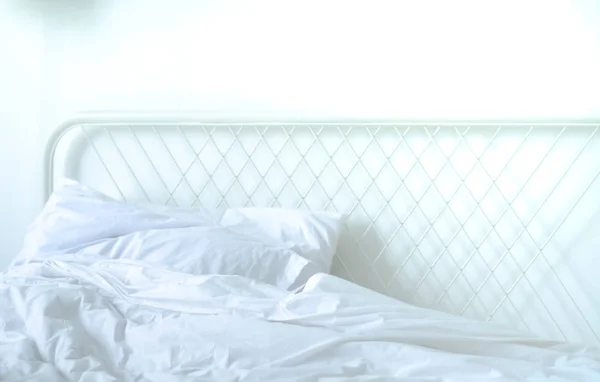 The white bed is in the sun-warmed bedroom in the morning. White bedroom in the morning.Do not focus on objects.