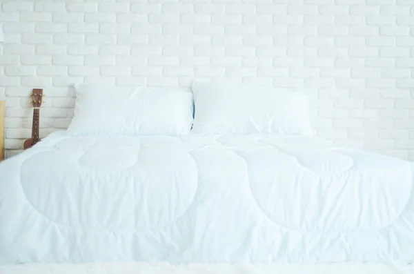 The white bed is in the sun-warmed bedroom in the morning. White bedroom in the morning.Do not focus on objects.