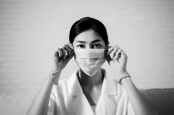 Asian girl wearing a black mask.Nose mask protects against dust on the face of  women.Blurred image for background use.Black and white photo editing.