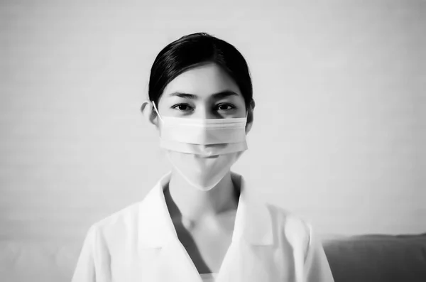 Asian girl wearing a black mask.Nose mask protects against dust on the face of  women.Blurred image for background use.Black and white photo editing.