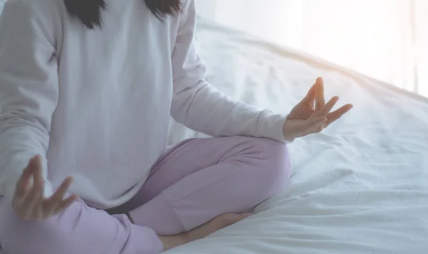 Asian girls sitting on yoga poses in bed in a warm morning.Warm tone.Do not  focus on objects. — sport, relax - Stock Photo | #266218532
