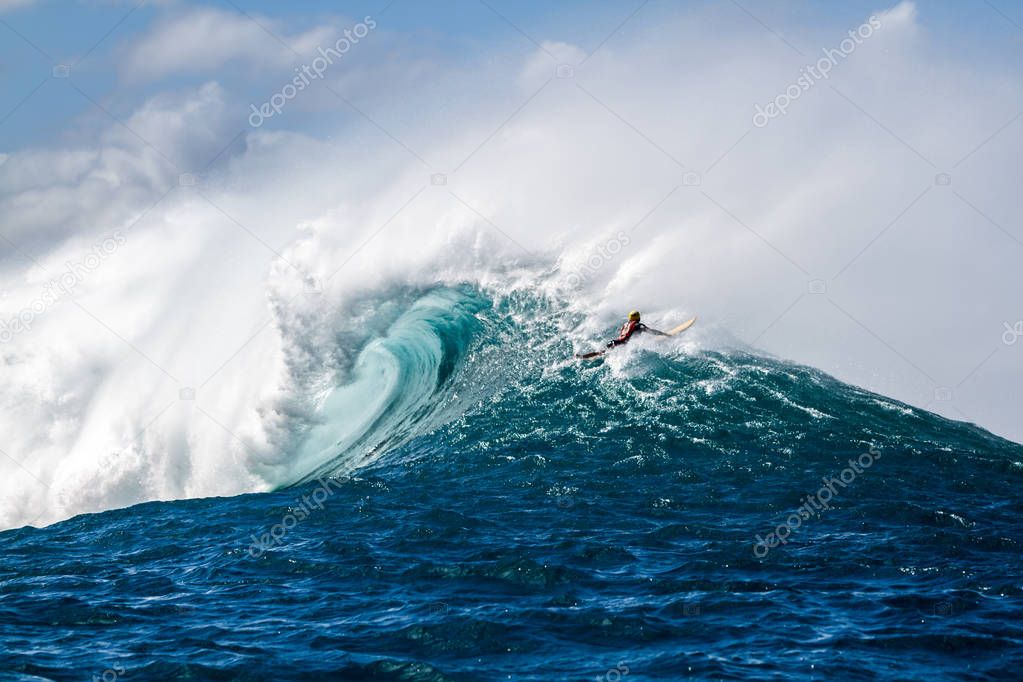 A Surfer going over a giant wave in Hawaii