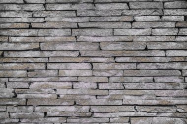 Doku ev dekorasyonu, doğal taştan yapılmış. Tuğla duvar arka planı. Boşluğu kopyala, metin ekle. Taş dokusu arka planı. İç dekorasyon için taş, endüstriyel yapı tasarımı