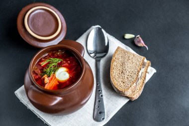 Kavanozda çorba. Etli sebze çorbası, ekşi krema ve koyu arkaplanda sarımsak. Geleneksel Slav mutfağı. Seçmeli olarak odaklan. Kopyalama alanı