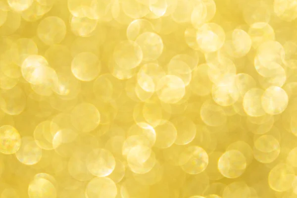 Abstract festive background. Beautiful golden abstract glitter glowing magic bokeh. Defocused Christmas background. Happy mood. Copy space.