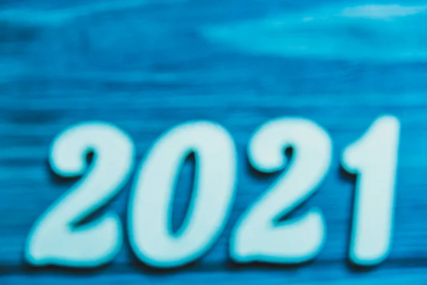 Blue numbers 2021 in blur on a blue background. The concept of the unknown, the mystery of the coming year. Copy space. — Stock Photo, Image