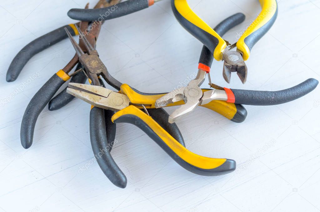 Metal jewelry making tools on the table. Creative craft