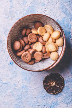 Hafif ahşap tahta üzerinde bir kapta birkaç sünger bisküvi