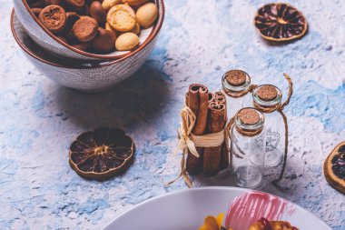 Birkaç tarçın ve hafif ahşap tahta üzerinde küçük cam şişe