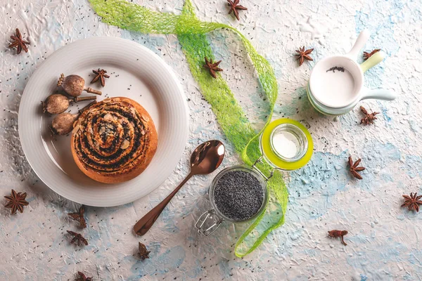 Zoete gerolde broodje met papaver op witte plaat met weinig poppyheads — Stockfoto