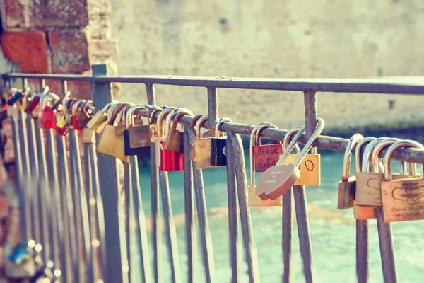 Vintage photo of several metal locks fixed to fence in Sirmione — 스톡 사진