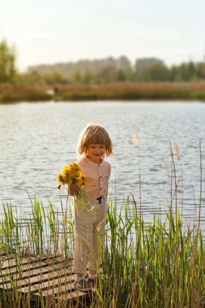 Little Boy Holding Bunch Yellow Dandelion Flowers Park Lake River — Stock Photo, Image